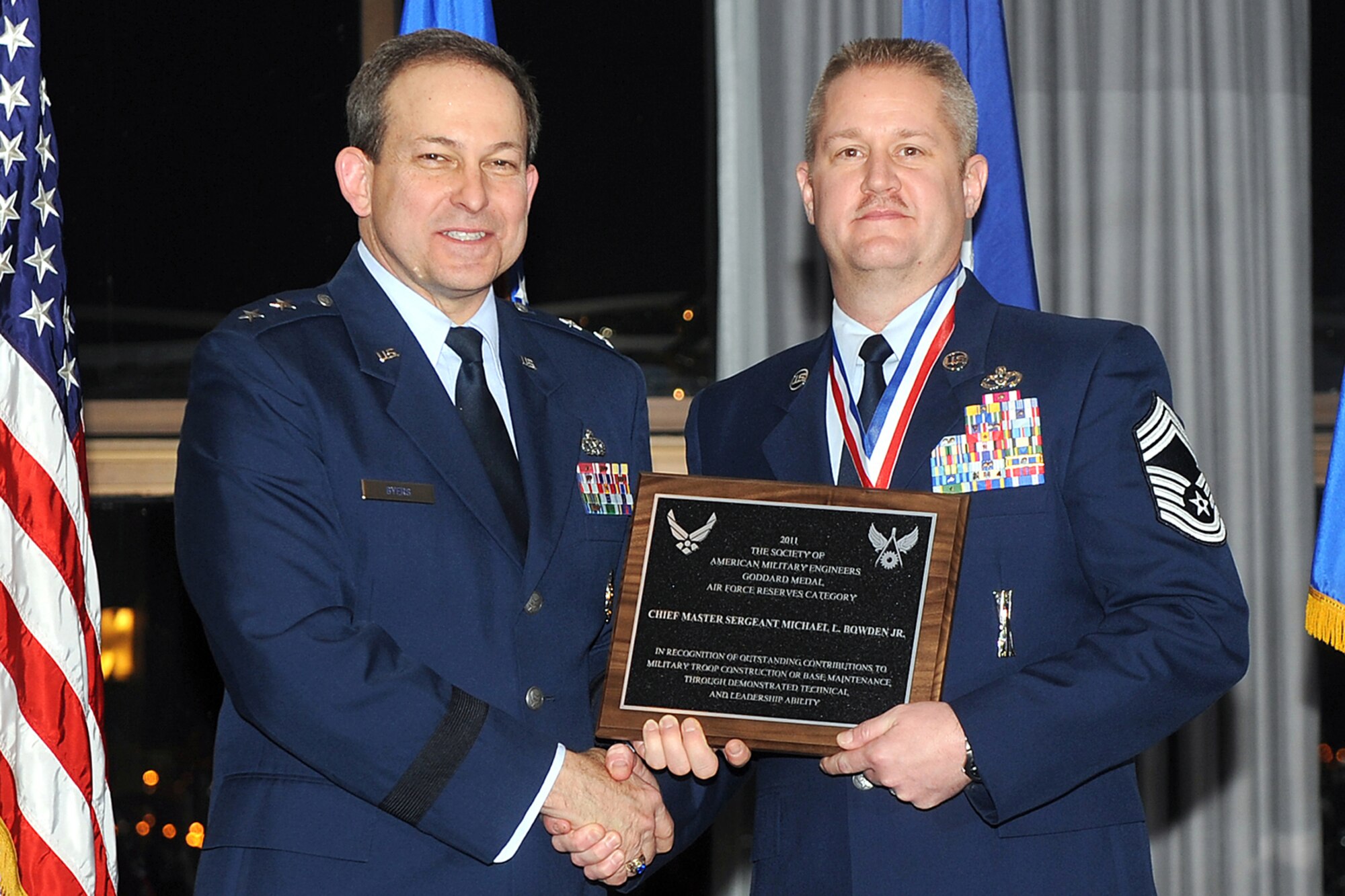Maj. Gen. Timothy Byers,  the Air Force Civil Engineer, presents Chief Master Sgt. Michael  L. Bowden Jr. with the 2011 Society of American Military Engineers Goddard Medal at the 50th Annual Civil Engineer Awards at Bolling Air Force Base, Washington, D.C., Feb. 23. Bowden, who is the 434th Civil Engineer Squadron manager, garnered that recognition amongst others for his recent deployment to Afghanistan. (U.S. Air Force photo/Andy Morataya)
