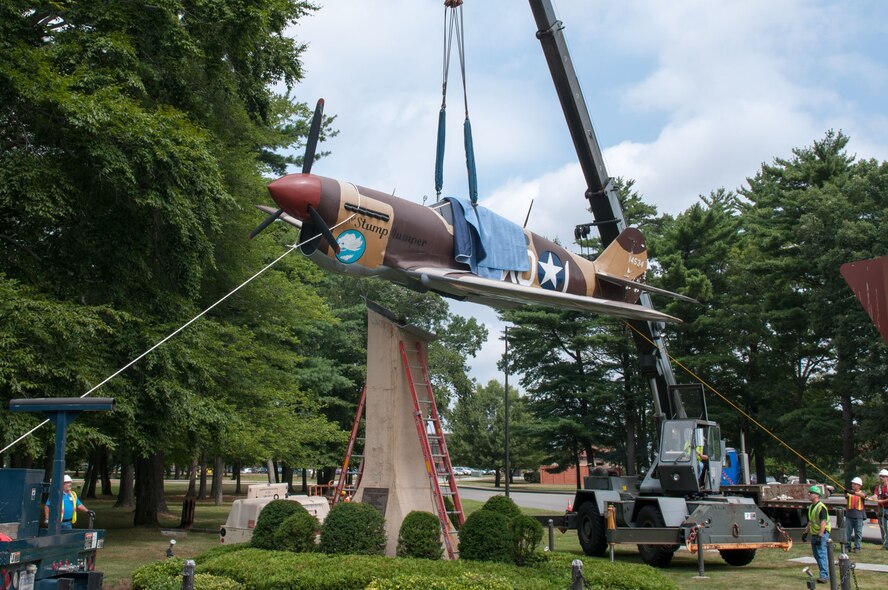 HANSCOM AIR FORCE BASE, Mass. – Crews remove the P-40 static display, at the corner of Vandenberg Drive and Marrett Street, from its pedestal Aug. 1. The plane was removed to undergo repair and restoration. (U.S. Air Force photo by Rick Berry)