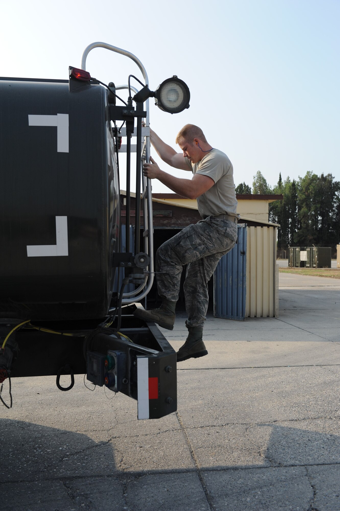 Airman 1st Class Noah Tegrootenhuis, 39th Logistics Readiness Squadron fuels distribution operator, climbs down a ladder after checking a manhole and a fuel truck Aug. 2, 2012, at Incirlik Air Base, Turkey. The 39th LRS has 18 trucks to deliver fuel for generators, aircraft and anything else needing the combustible energy source. (U.S. Air Force photo by Senior Airman Anthony Sanchelli/Released)
