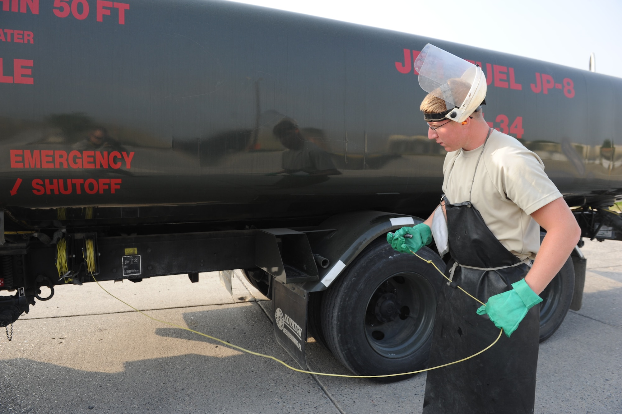 Airman 1st Class Ethan Retallack, 39th Logistics Readiness Squadron fuels distribution operator, extends a grounding cable from a fuel truck Aug. 2, 2012, at Incirlik Air Base, Turkey. The cable is attached to a metal post in the ground to eliminate static electricity, which could ignite the fuel. (U.S. Air Force photo by Senior Airman Anthony Sanchelli/Released)
