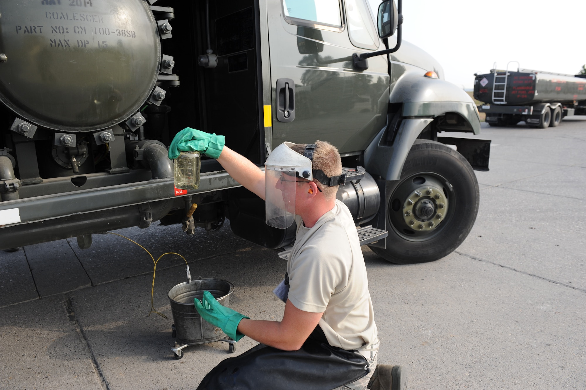 Airman 1st Class Ethan Retallack, 39th Logistics Readiness Squadron fuels distribution operator, checks for water in fuel tanks Aug. 2, 2012, at Incirlik Air Base, Turkey. Retallack checks the fuel in all the trucks to ensure it is usable. (U.S. Air Force photo by Senior Airman Anthony Sanchelli/Released)
