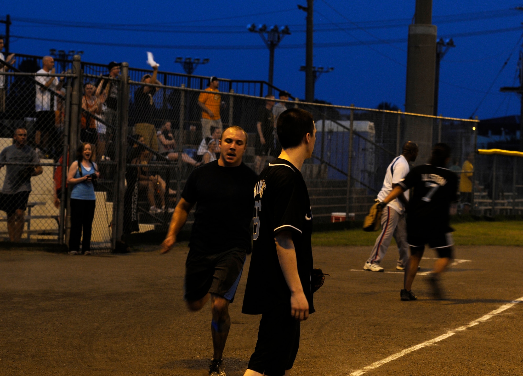 U.S. Navy Petty Officer 2nd Class Anthony Bonilla, Commander Task Force 72 shortstop, comes in to score the game tying run in the bottom of the seventh inning during the intramural softball championship game at Misawa Air Base, Japan, Aug. 1, 2012. A few moments later CTF-72 scored the game winning run with a base hit that won them the championship over the 35th Force Support Squadron by a score of 14 to 13. (U.S. Air Force photo by Airman 1st Class Zachary Kee/Released)