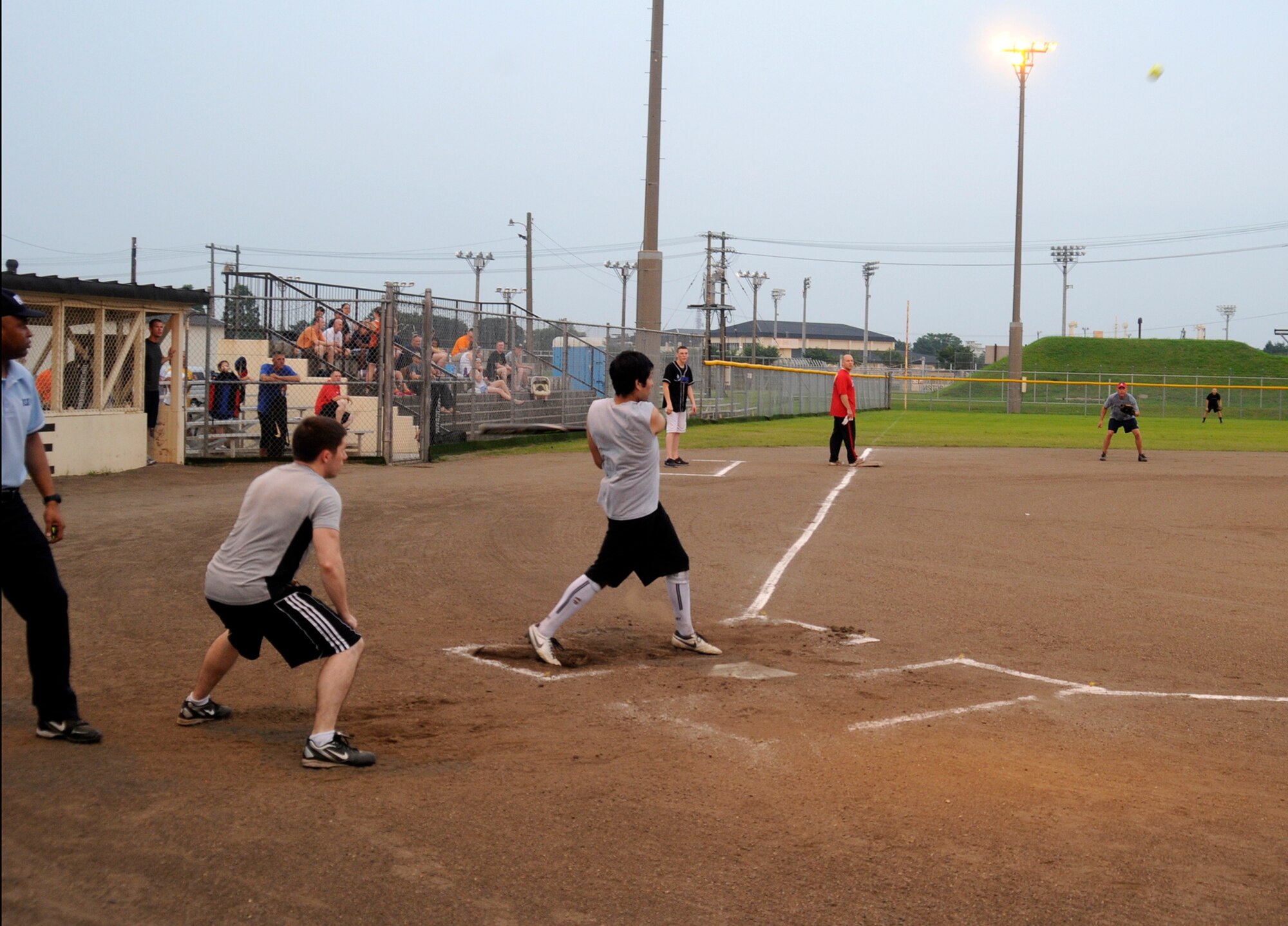 Mr. Ray Keiser, 35th Force Support Squadron softball team member, hits a high-fly ball to the outfield during the intramural softball championship game at Misawa Air Base, Japan, Aug. 1, 2012. The 35 FSS took a 13 to 12 lead into the bottom of the seventh inning, but Commander Task Force 72 stole the show by hitting a walk-off single to win the championship game 14 to 13. (U.S. Air Force photo by Airman 1st Class Zachary Kee/Released)