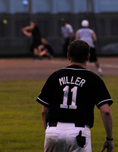 Mr. Blaine Miller, 35th Force Support Squadron softball team coach, gets ready to react to a hit from his left-field position during the intramural softball championship game at Misawa Air Base, Japan, Aug. 1, 2012. Miller and his team lost in seven innings in the championship game to Commander Task Force 72. (U.S. Air Force photo by Airman 1st Class Zachary Kee/Released)