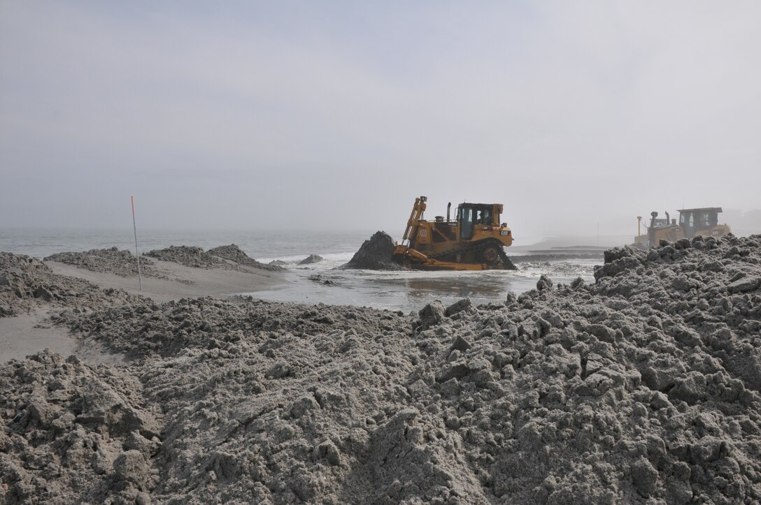 Bulldozers push sand into a berm and dune system at Brant Beach, NJ during a 2012 beachfill project. 