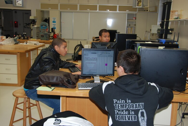 Zama American High School Students (Josh Mumford (front), Christopher Reynolds (left) and Alan Deloney (facing) each designs his bridge as part of the 2012 West Point Bridge Design Contest Feb 23.  Japan District engineers sponsored by ZAHS and Japan Engineer District. (Official photo by T.W. Lyman, released)