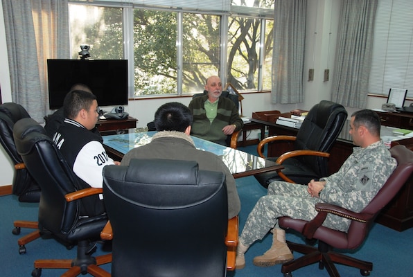 Col. Bryan P. Truesdell, Zama High School career and technical education instructor Jay Ruetten and Team GAS discuss the results of the 2011 Bid Proposal contest sponsored by Zama American High School and Japan District, U.S. Army Corps of Engineers Jan. 18, 2012. (Photo by T. W. Lyman)