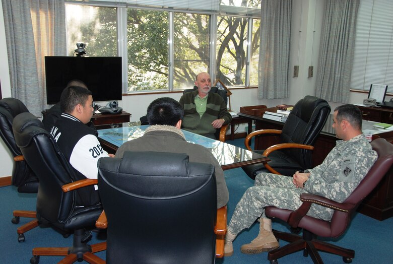 Col. Bryan P. Truesdell, Zama High School career and technical education instructor Jay Ruetten and Team GAS discuss the results of the 2011 Bid Proposal contest sponsored by Zama American High School and Japan District, U.S. Army Corps of Engineers Jan. 18, 2012. (Photo by T. W. Lyman)