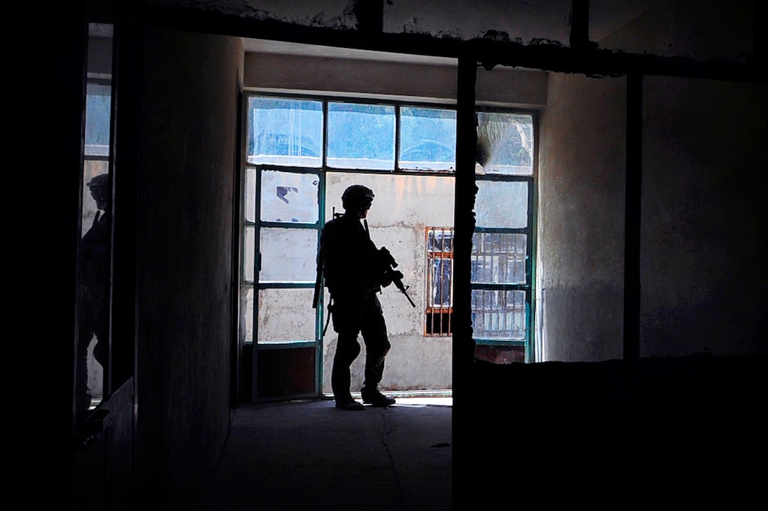 U.S. Army Staff Sgt. Daniel Nelson provides security during a key leader engagement at Malaa Lay Maiwand School in Farah City, Afghanistan's Farah province, Aug. 1, 2012. Nelson is assigned to the Provincial Reconstruction Team Farah, security force team. The PRT members are engaging local school officials to assess the condition of city schools and encourage student participation.