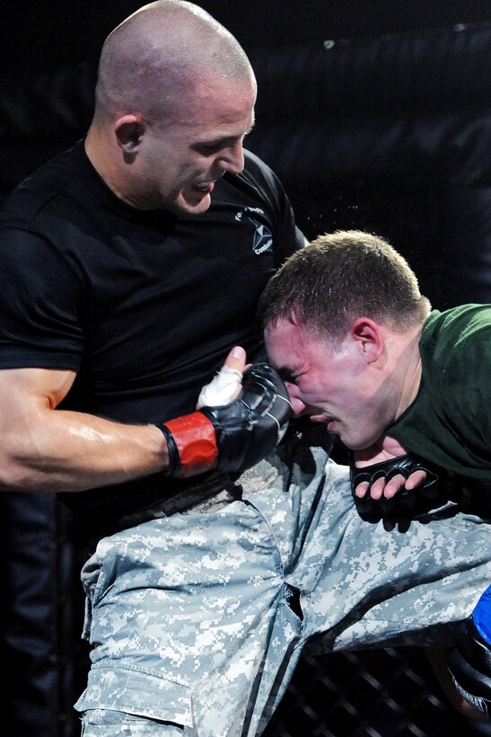 Army 2nd Lt. Nick Shafer, left, strikes Army 1st Lt. Mathew Kyler during the finals of the welterweight division of the 2012 U.S. Army Combatives Championship on Fort Hood, Texas, July 28, 2012. Shafer, assigned to Fort Hood, Texas, won the match. Kyler is assigned to Fort Carson, Colo.