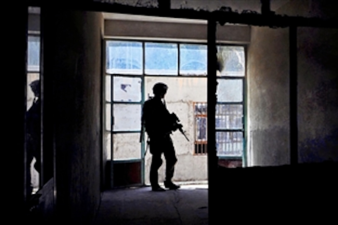 U.S. Army Staff Sgt. Daniel Nelson provides security during a key leader engagement at Malaa Lay Maiwand School in Farah City in Afghanistan's Farah province, Aug. 1, 2012. Nelson is assigned to Provincial Reconstruction Team Farah, whose members met with local officials to assess the condition of city schools and encourage student participation.