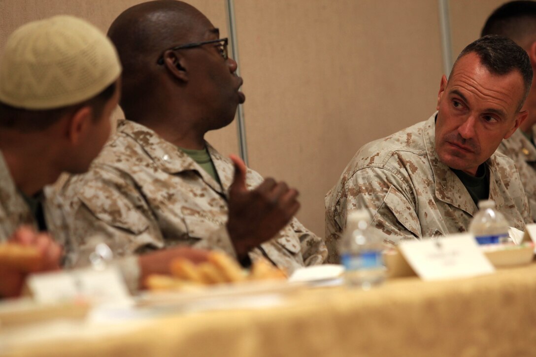 During an Iftar meal Brig. General Vincent A. Coglianese, commanding general of Marine Corps Installations West, Marine Corps Base Camp Pendleton speaks with base chaplains, U.S. Navy Capt. Ollis J. Mozon and U.S. Navy Lt. Asif I. Balbale at the Blinder Memorial Chapel, Aug. 2.  Iftar allows fasting Muslims to break fast with an evening meal that takes place at sunset each night during the Islamic holy month of Ramadan.