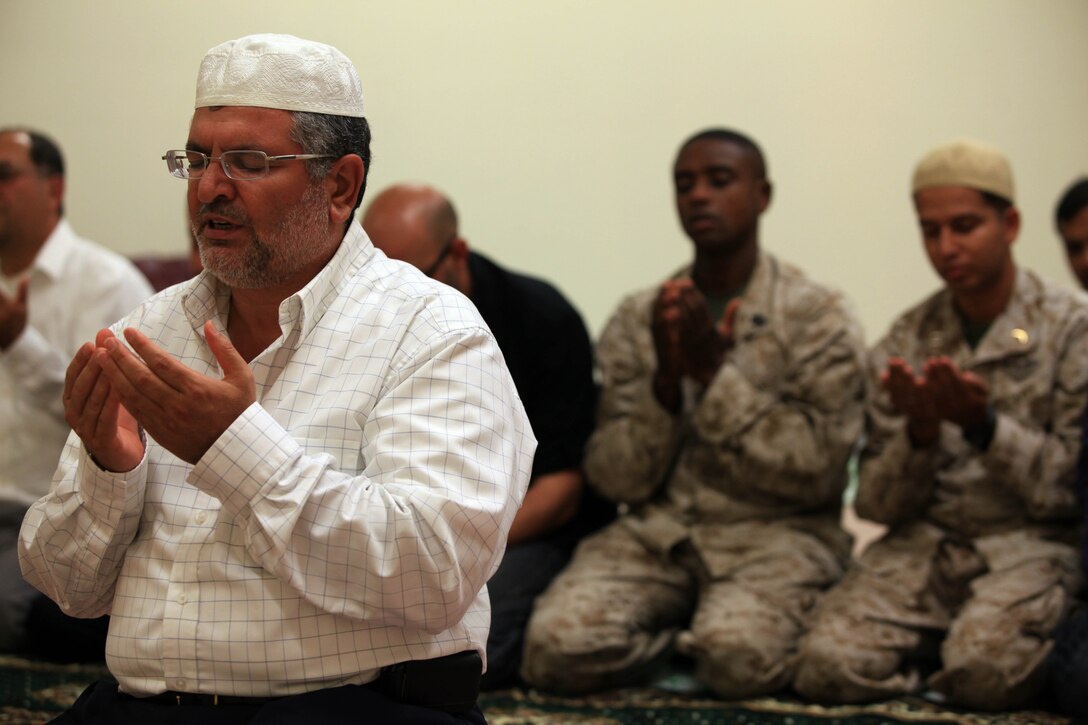 Mahmoud Harmoush, the imam of the Islamic Center of Temecula Valley, leads prayer during an Iftar celebration at the Blinder Memorial Chapel, Aug. 2.  Iftar allows fasting Muslims to break fast with an evening meal that takes place at sunset each night during the Islamic holy month of Ramadan.::r::::n::