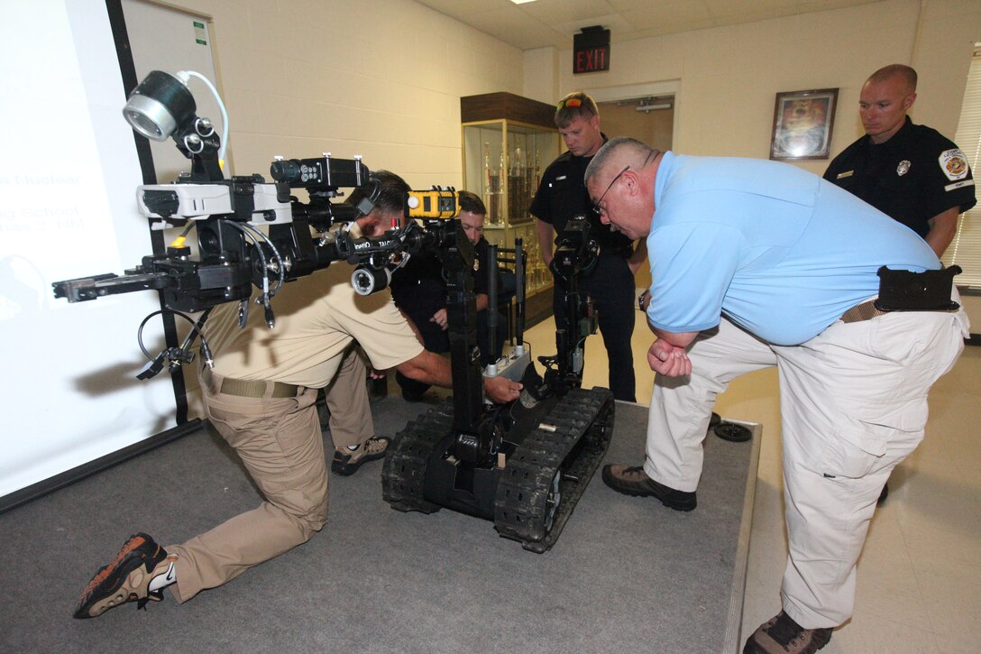 Firefighters from Marine Corps Base Camp Lejeune take a close look at the Talon robot during a demonstration at the fire department training area aboard MCB Camp Lejeune July 30 and 31. The Talon was fitted with chemical, biological, radiological, nuclear and explosive add-ons to meet the practical functions in a hazardous-material environment. 