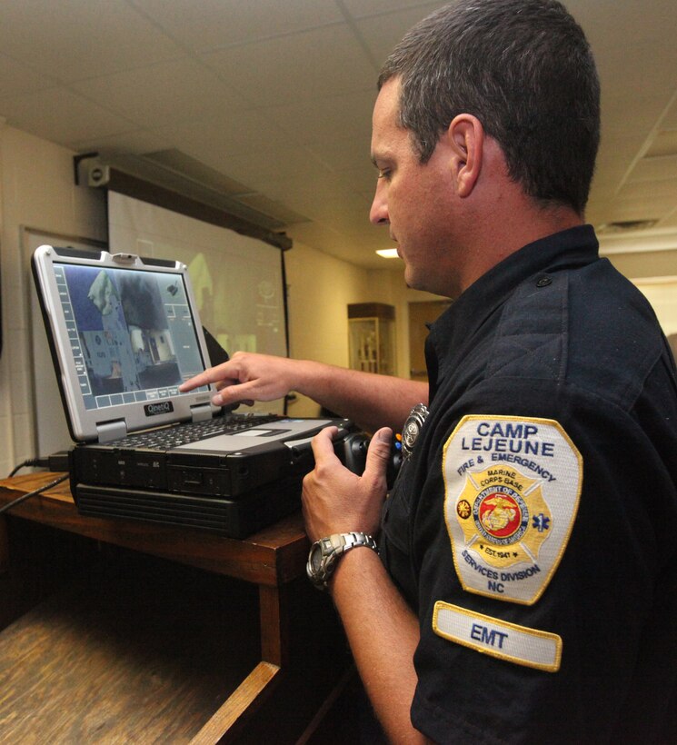 A firefighter from Marine Corps Base Camp Lejeune practices controlling the Talon robot during a demonstration at the fire department training area aboard MCB Camp Lejeune July 30 and 31. Commanders can communicate with a response team through a public address system mounted on the robot, and four mounted cameras provide live feedback to the operator’s laptop controller.