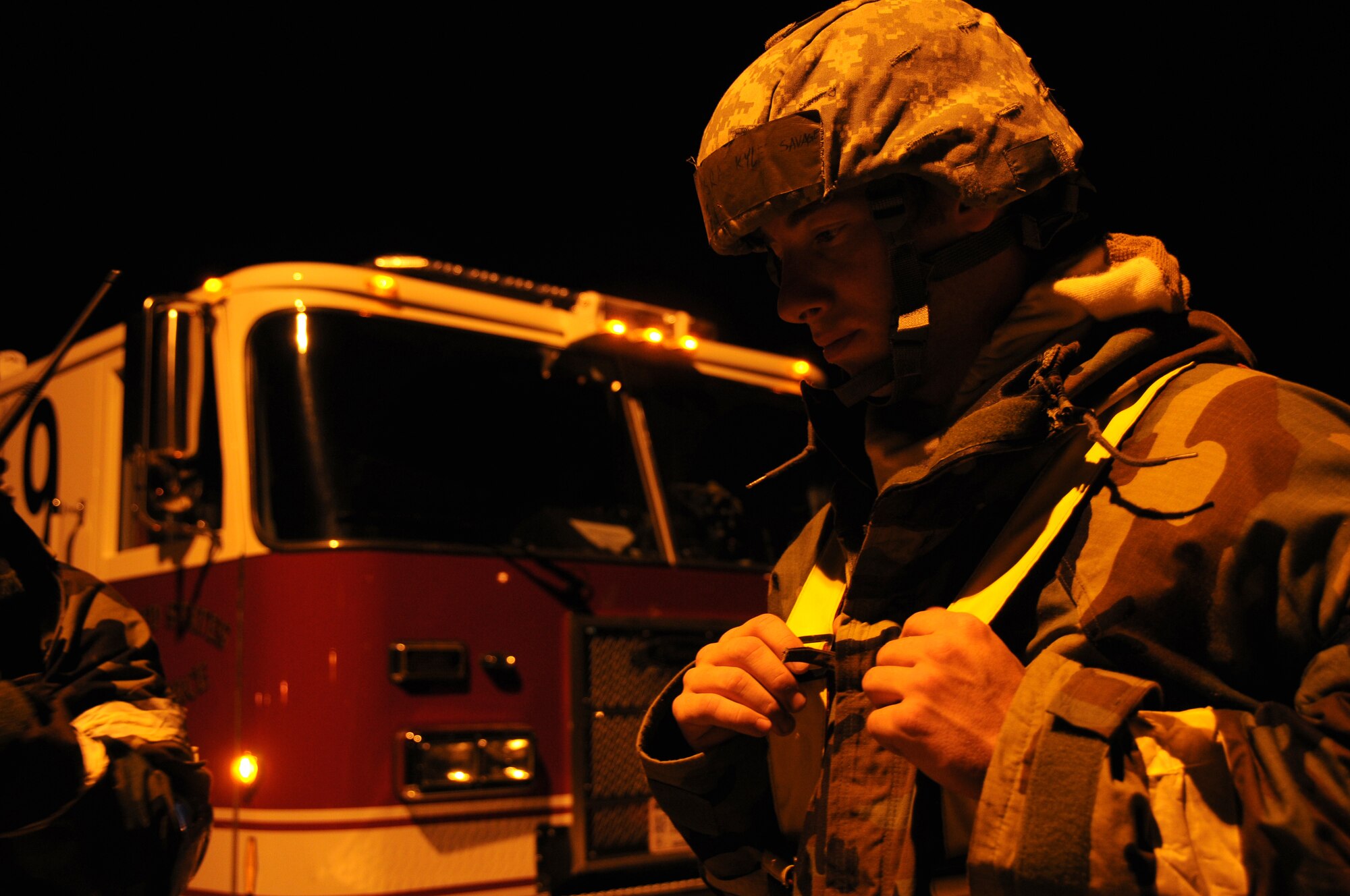 ALPENA COMBAT READINESS TRAINING CENTER, Mich. – Senior Airman Kyle Savage, 914th Civil Engineering Squadron fire department, waits for a response over the radio on current security conditions across the base during an Operational Readiness Inspection here July 22, 2012. Keeping current on alarm conditions and Mission Oriented Protective Posture (MOPP) levels ensures all Airmen can perform their duties safely. (U.S. Air Force photo by Senior Airman Jessica Mae Snow)