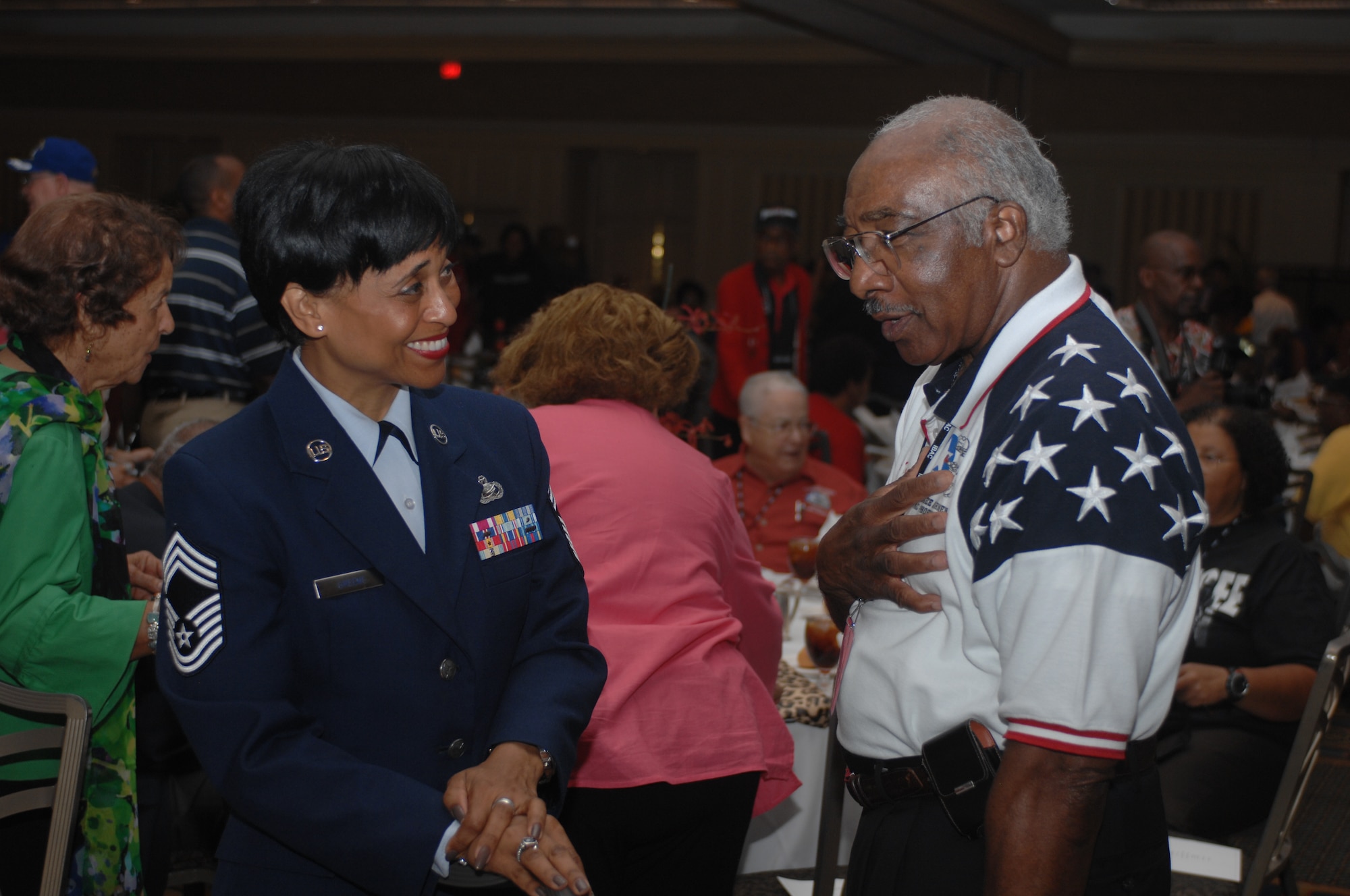 Chief Master Sgt. Wanda Greene, 622nd Regional Support Group out of Dobbins Air Reserve Base, Ga. speaks with Retired Col. Richard Toliver, a Tuskegee Airman, at a youth lunch Aug. 2, 2012 in downtown Las Vegas, Nev. during the 41st Annual Tuskegee Airmen, Inc. National Convention.  Toliver was a former instructor pilot at the United States Air Force Tactical Fighter Weapons School here.(U.S. Air Force photo by Senior Airman Jack Sanders)