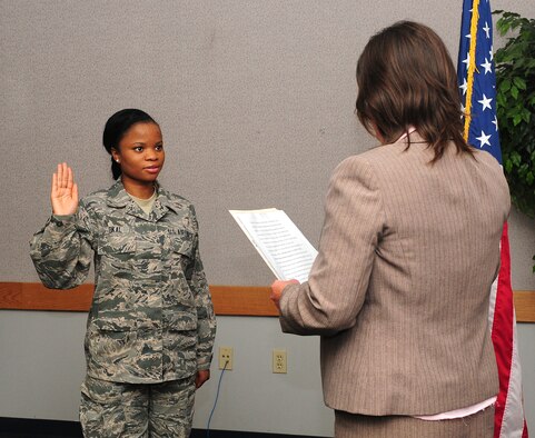 Airman 1st Class Princess Okai, 9th Force Support Squadron, food service apprentice performs the Oath of Allegiance to the United States of America at the Airman Family Readiness Center at Beale Air Force Base Calif., July 27, 2012. Okai is one of more than 11,000 foreign born women serving in the armed forces as of February 2008. (U.S. Air Force photo by Senior Airman Allen Pollard/Released)