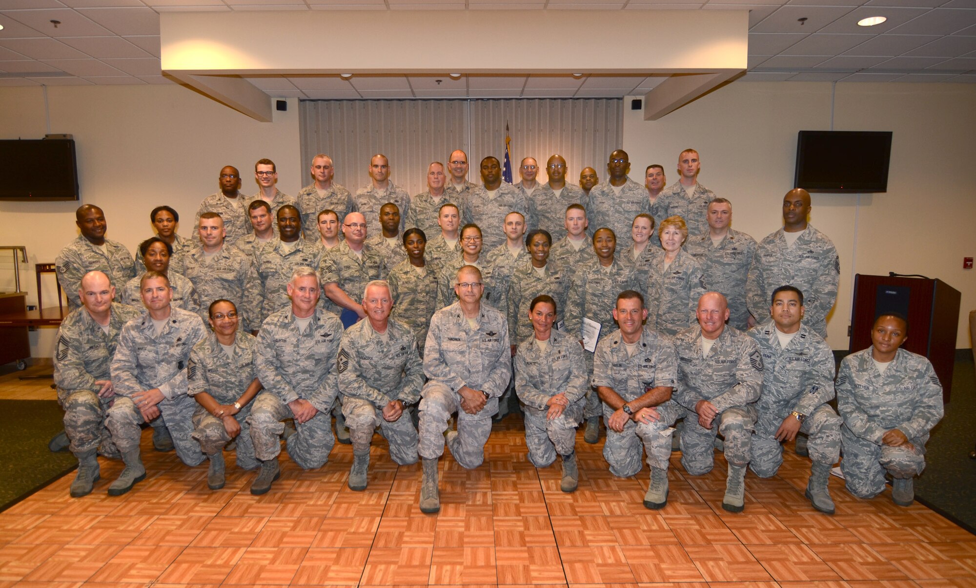 Senior leadership and graduates of the Noncommissioned Officer Leadership Development Course gathered here to commemorate their completion of the two-week leadership course. The course combines college-level academic management and leadership instruction with hands-on experience (U.S. Air Force Photo/Brad Fallin)