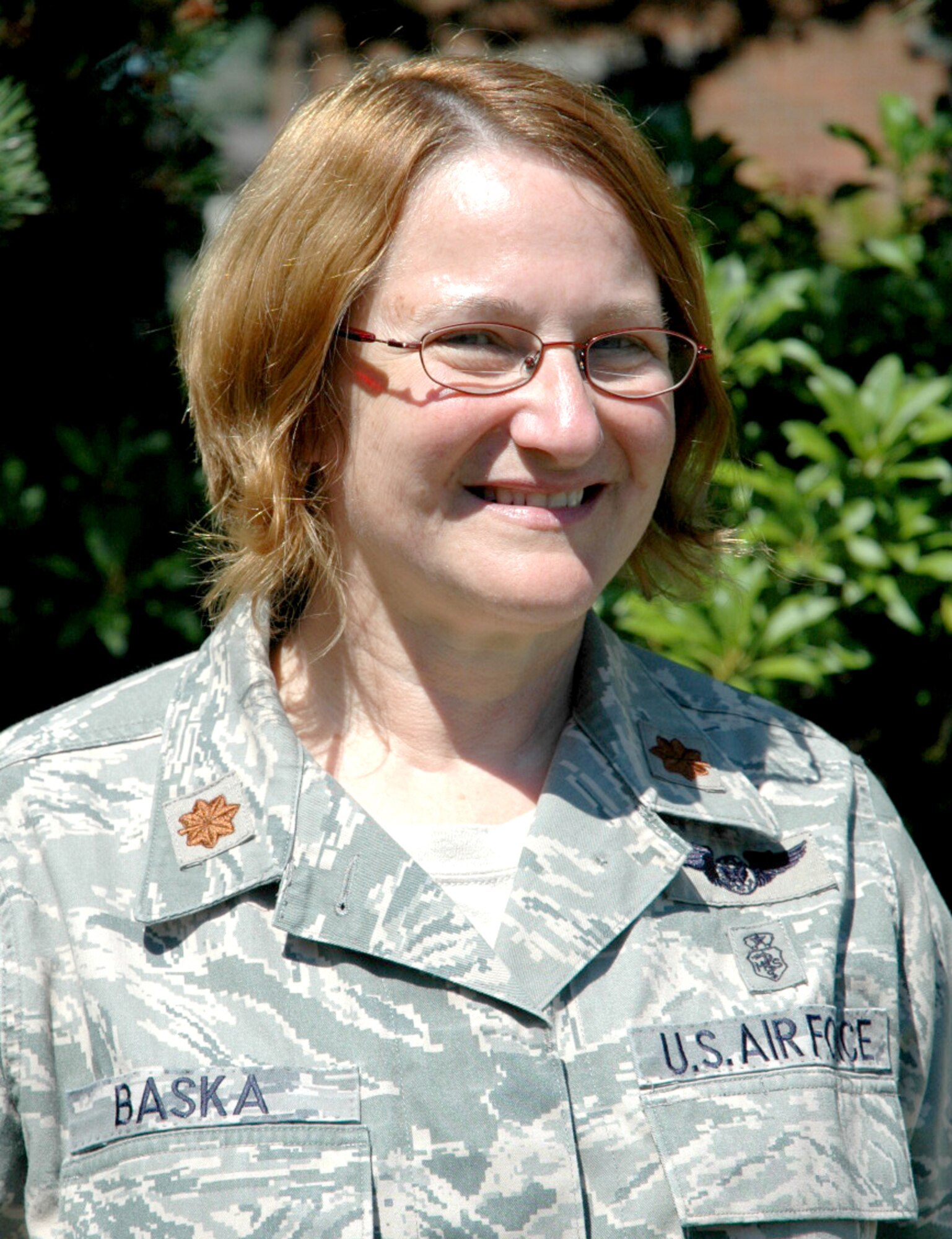 Maj. Maryjane Baska, 446th Aeromedical Evacuation Squadron, is digitizing the squadron's history before she retires next March.  Her efforts have been rewarded with a positive response when following up on a former patient airlifted from Thailand 37 years ago. (U.S. Air Force photo by Sandra Pishner)