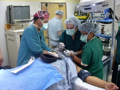 U.S. Navy Ensign Kristen Birmingham assists with intubation on a patient prior to a tonsillectomy in a Honduran hosptial here. Her and three other medical students from the Uniformed Services University of the Health Sciences in Bethesda, Md. visited Joint Task Force-Bravo to participate in a two-week Summer Operational Experience program. The SOE is designed to provide a military experience to junior officers to enhance their understanding of the service branches and life as a military medical officer. (Courtesy photo by Deborah Maynard) 
