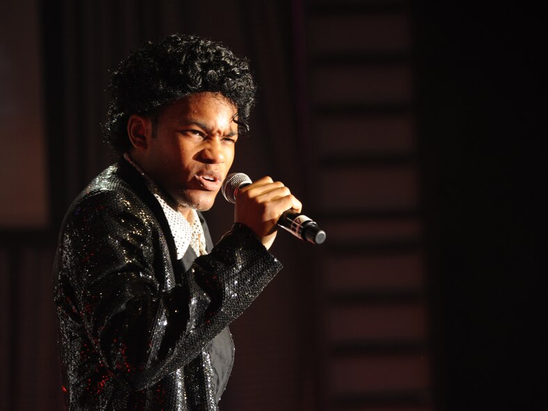 Staff Sgt. Tyron Jones, Tops in Blue vocalist dressed as Michael Jackson, sings to the Barksdale community during the 2012 World Tour, "Listen", at Hoban Hall on Barksdale Air Force Base, La., Aug. 2. The performance included many Michael Jackson songs including "Thriller" and "Smooth Criminal". (U.S. Air Force photo/Airman 1st Class Benjamin Gonsier)(RELEASED)