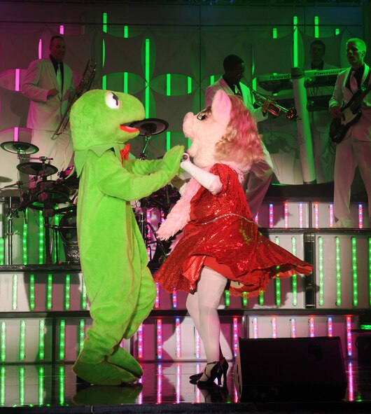 Tops in Blue performers dressed up as Kermit the Frog and Miss Piggy, from Jim Henson's "The Muppets", sing and dance for the Barksdale community during the 2012 World Tour, "Listen", at Hoban Hall on Barksdale Air Force Base, La., Aug. 2. Their world tour invites the audience to listen to the music of life through the sounds Airmen hear every day. (U.S. Air Force photo/Airman 1st Class Benjamin Gonsier)(RELEASED)