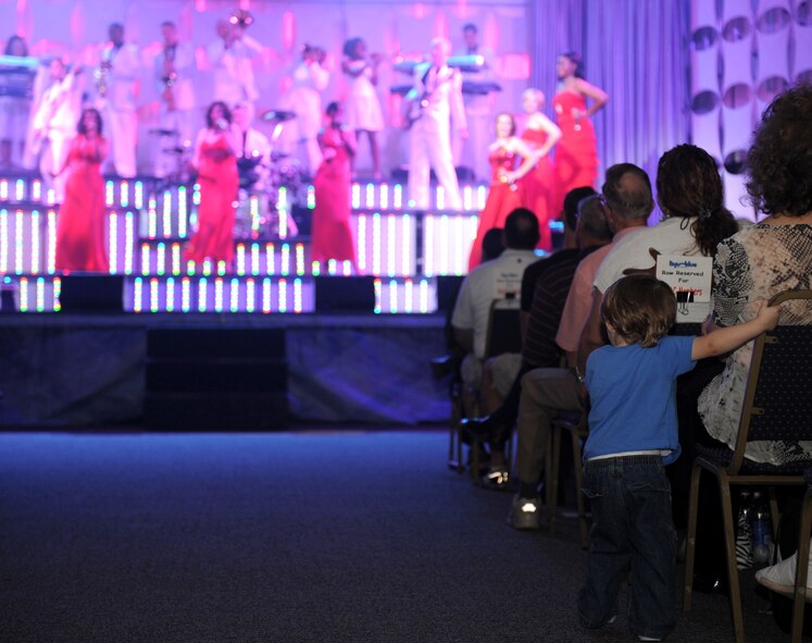 A boy gets a better view of the Tops in Blue performance during the 2012 World Tour, "Listen", at Hoban Hall on Barksdale Air Force Base, La., Aug. 2. More than 1,000 Barksdale team members came to Hoban Hall to watch Tops in Blue perform. (U.S. Air Force photo/Airman 1st Class Benjamin Gonsier)(RELEASED)