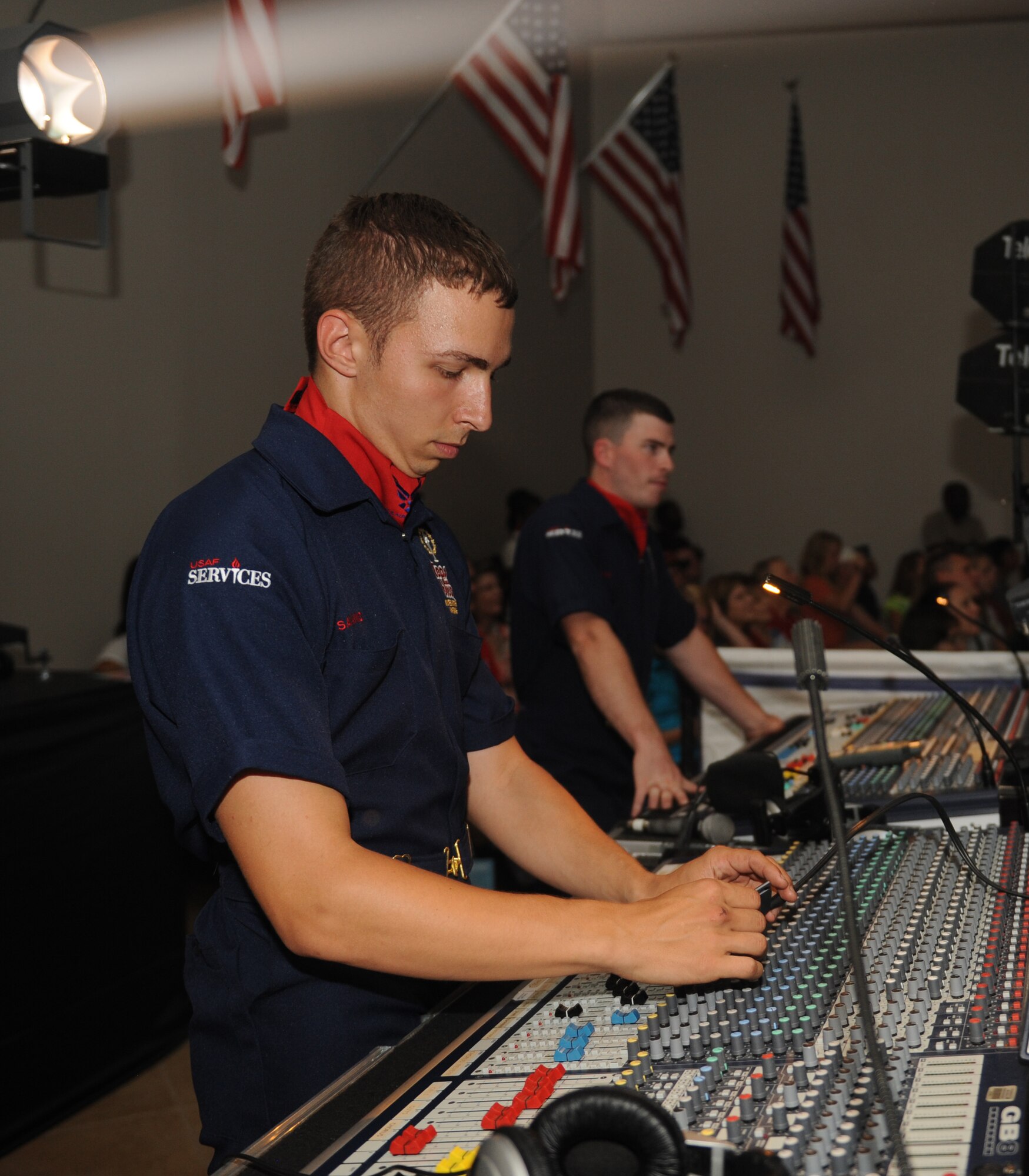 Senior Airman Julian Saviano, Tops in Blue audio director, adjusts the sound during the Tops in Blue 2012 World Tour, "Listen", at Hoban Hall on Barksdale Air Force Base, La., Aug. 2. The technical staff consists of seven well-trained Airmen who specialize in video, lighting, staging and vehicle operations. (U.S. Air Force photo/Airman 1st Class Benjamin Gonsier)(RELEASED)
