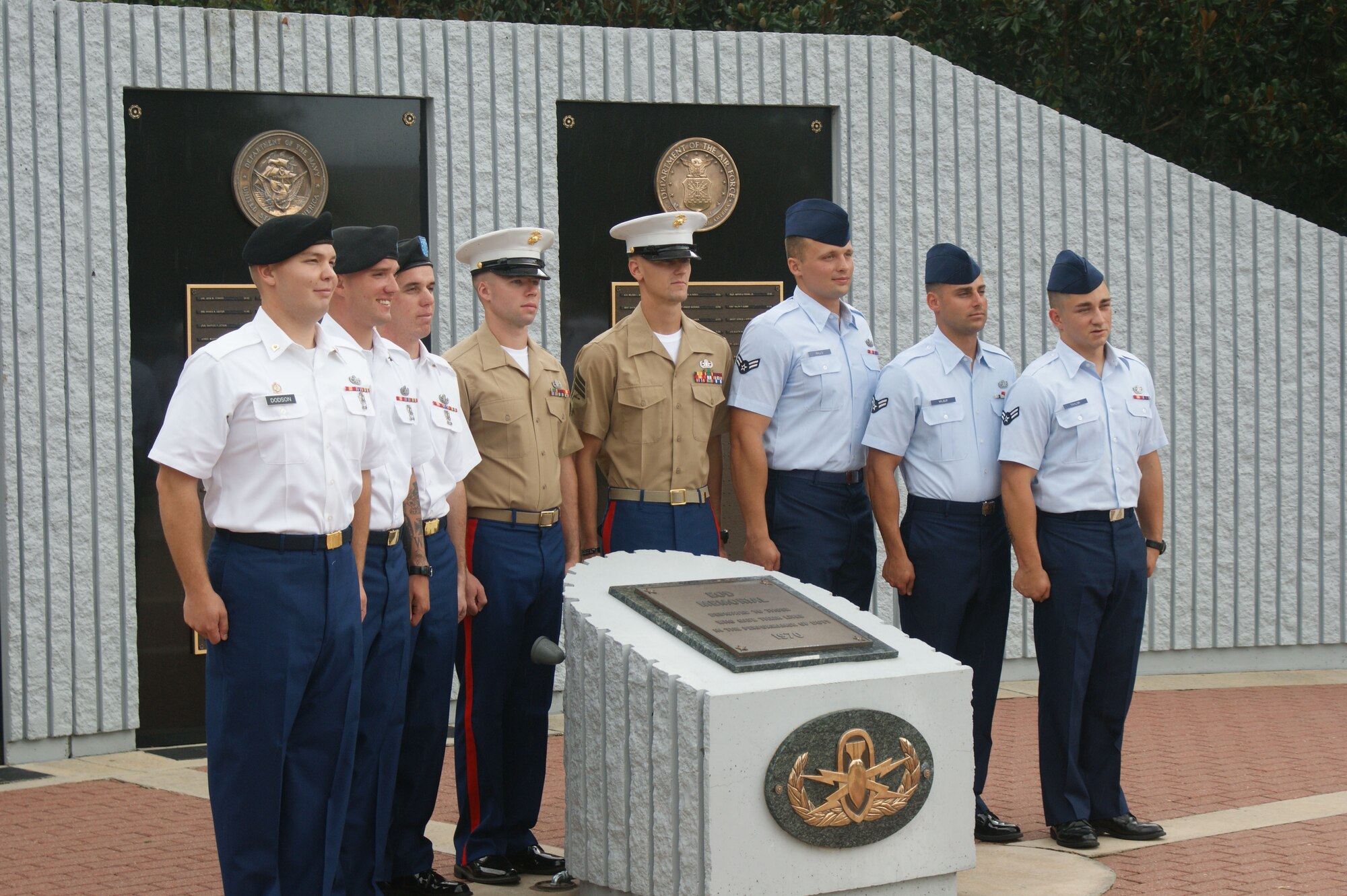 Airman 1st Class Buck Taylor (far right), Airman 1st Class Jason Wilbur (2nd from right) and Airman 1st Class Jessie Ralls (3rd from right) pose for pictures with their fellow classmates in front of the EOD Memorial at Naval School Explosive Ordnance Disposal Jul. 20, 2012 at Eglin Air Force Base, Florida.  The Airmen graduated the seven-month long course and will be heading to their respective first duty assignments as fully-qualified EOD technicians.  (U.S. Air Force photo/Dan Hawkins)
