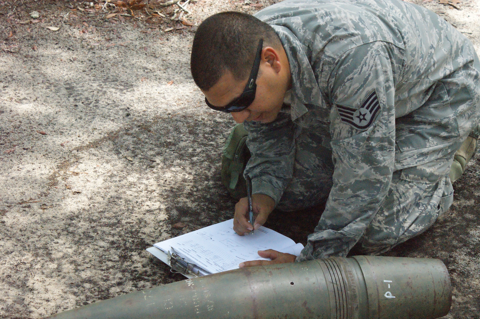 Staff Sgt. Ricardo Porto, NAVSCOLEOD student, conducts a reconnaissance training problem during Core Division training Jul. 19, 2012, at Eglin Air Force Base, Fla.  Students must pass all nine divisions of the EOD basic course before earning their "crab" . (U.S. Air Force photo/Dan Hawkins)