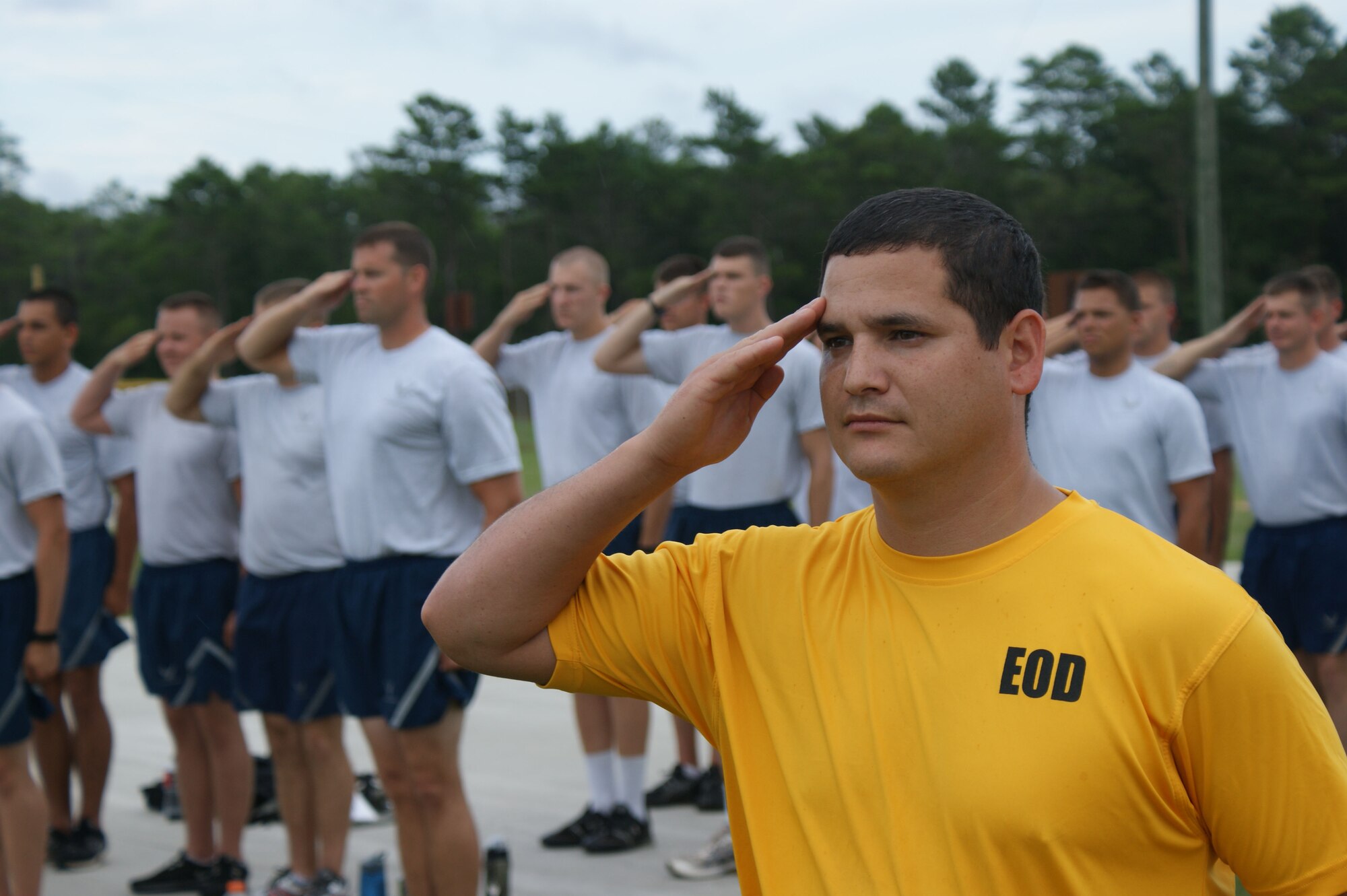 Staff Sgt. Aaron Cantu, EOD instructor at NAVSCOLEOD, salutes the colors during retreat prior to initiating a Battlefield Survivability thru Physical Fitness training evolution Jul. 19, 2012 at Eglin Air Force Base, Florida.  The phased fitness program ramps up in intensity as the students progress through EOD training, turning out technicians ready to handle the day-to-day rigors of deployed life.  (U.S. Air Force photo/Dan Hawkins)