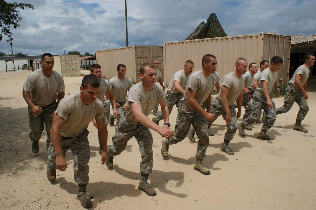 Airmen-in-training at Naval School Explosive Ordnance Disposal particpate in a physical training evolution Jul. 20, 2012 at Eglin Air Force Base, Florida.  Being in peak physical fitness is a key component of the seven-month EOD basic course.  (U.S. Air Force photo/Dan Hawkins)