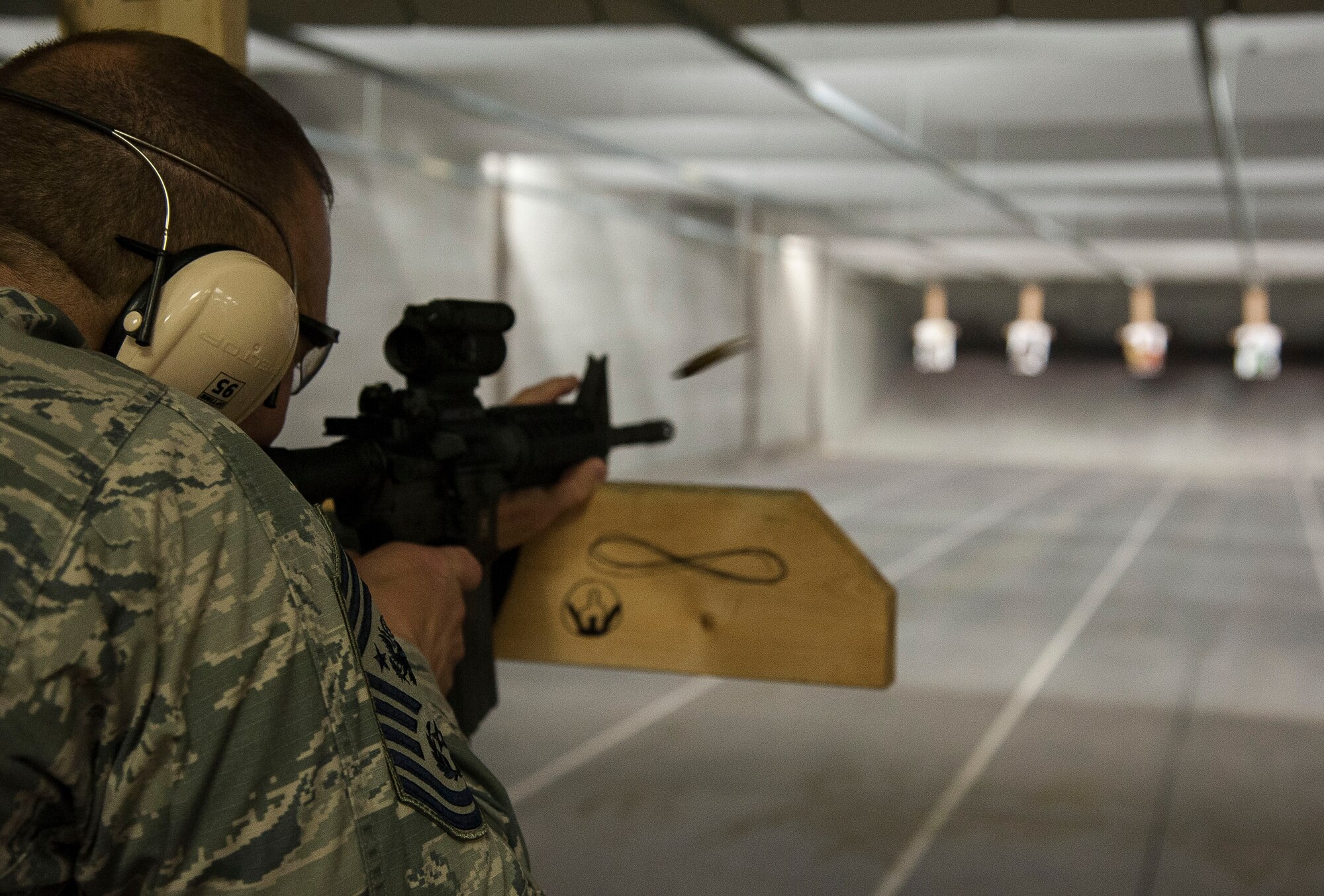 GOODFELLOW AIR FORCE BASE, Texas-- Chief Master Sgt. of the Air Force James A. Roy fires a M4 Carbine at the 17th Security Forces Squadron indoor range Aug. 1. Roy visited Goodfellow to experience the mission of the base and to meet with enlisted Airmen to discuss various topics and address their concerns. (U.S. Air Force Photo/Airman 1st Class Michael Smith)