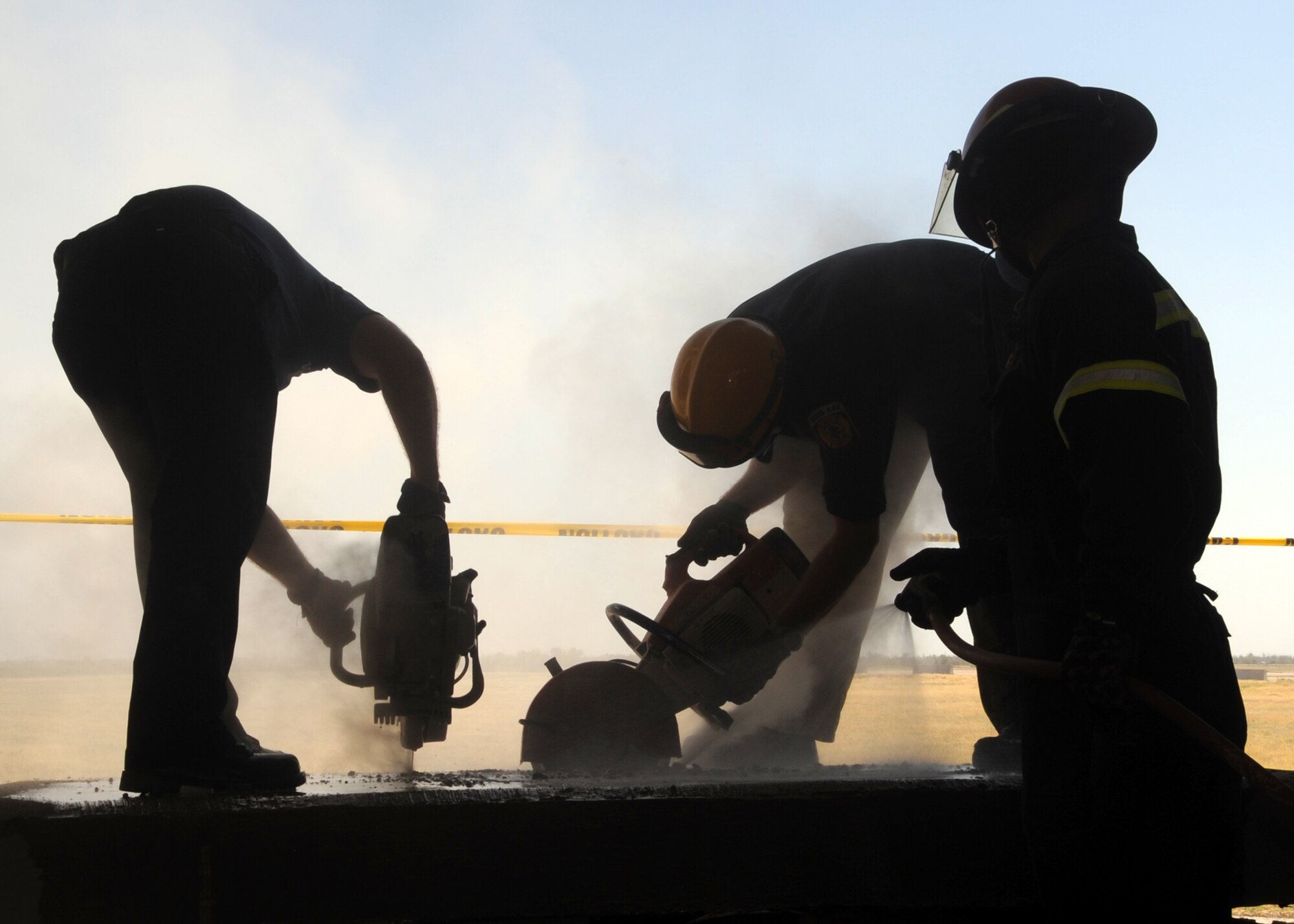 ALTUS AIR FORCE BASE, Okla. – Airmen from the 97th Civil Engineer Squadron, cut through a concrete slab during a structural collapse exercise at the Altus AFB training pit, Aug. 3, 2012. Members from the 97th CES fire department completed an advanced structural collapse exercise evaluation monitored by Tech-ResQ trainers to help stay current on training. The exercise simulated a collapsed building in which the firefighters had to cut holes in walls, floors and ceilings to access them. They also built shores to help support collapsing floors and ceilings. (U.S. Air Force photo by Airman 1st Class Franklin R. Ramos / 97th Air Mobility Wing / Released)