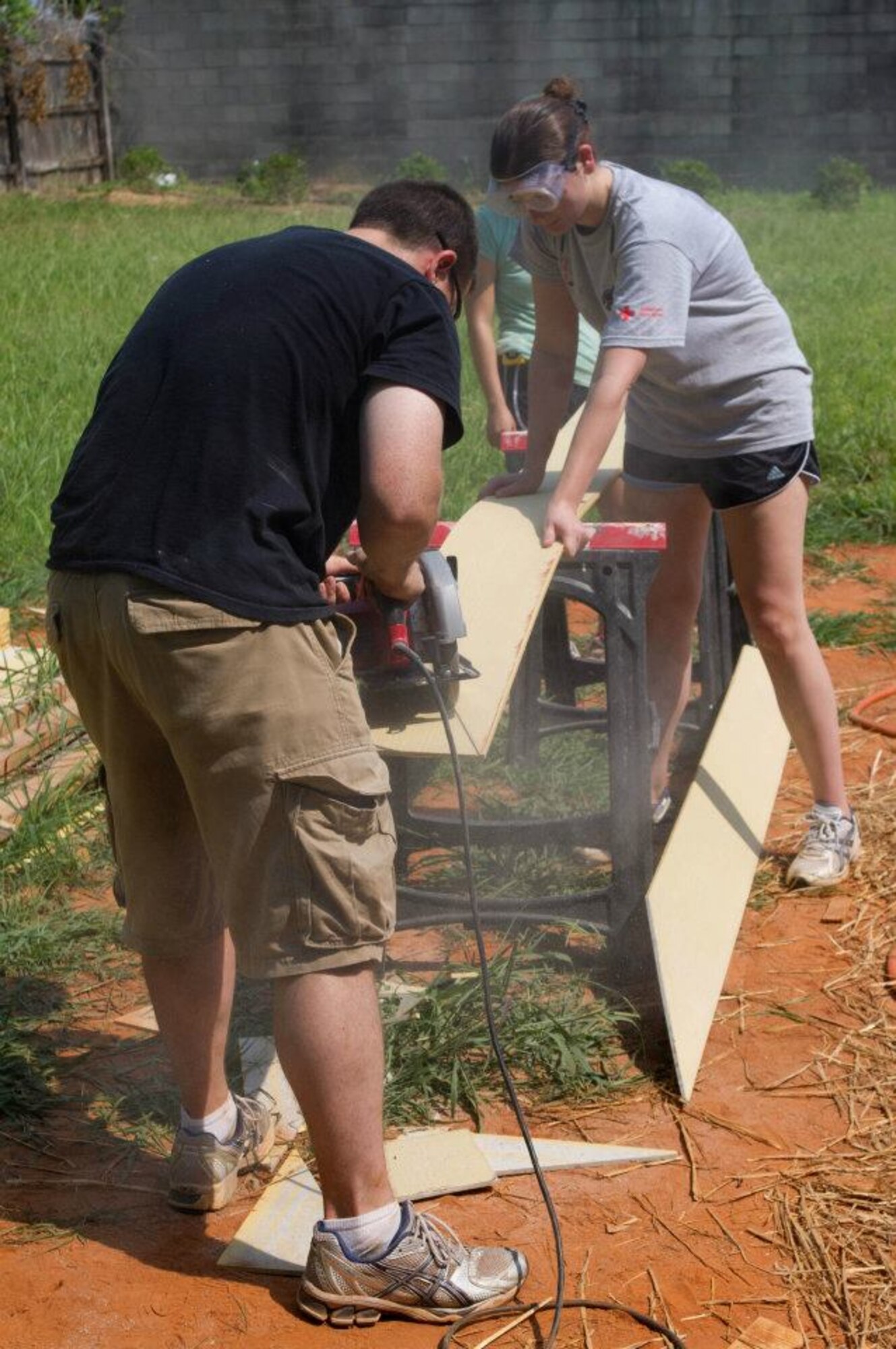 Students from Maxwell's Squadron Officer School class 12D volunteer rebuilding a home in the Montgomery Habitat for Humanity New Hope Village, July 14. For the last month, more than 190 students from the class have worked to restore the house that was destroyed by fire in April. (Courtesy photo) 