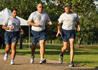 Flanked by Running Clinic leaders 2nd Lieutenant Dalia Delannoy, 919th Mission Support Group, and Master Sgt. Dan Landrum, 919th Security Forces Squadron, Senior Master Sgt. William Goodman, 919th Maintenance Squadron, receives tips on optimal running stride and pacing during a recent Fit-to-Fight training run at Duke Field, Fla.  The program gives Airmen the tools they need to improve the way they train for and complete the running portion of their Fit-to-Fight tests. (U.S. Air Force photo/Dan Neely)