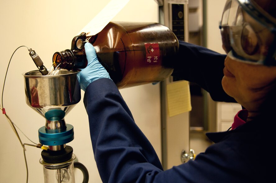 Dana Vuong, U.S. Naval Supply Fleet Logistic Center Pearl Harbor fuels department laboratory technician, sampling fuel during a bottle method test analysis July 27 to test for solids content in the fuel. The Airmen and Navy civilians operating the U.S. Naval Supply Fleet Logistic Center Pearl Harbor fuels department on Hickam Field pumped more than 10 million gallons of fuel to support air operations for RIMPAC. Twenty-two nations, more than 40 ships and submarines, more than 200 aircraft and 25,000 personnel are participating in RIMPAC exercise from Jun. 29 to Aug. 3, in and around the Hawaiian Islands. The world's largest international maritime exercise, RIMPAC provides a unique training opportunity that helps participants foster and sustain the cooperative relationships that are critical to ensuring the safety of sea lanes and security on the world's oceans. RIMPAC 2012 is the 23rd exercise in the series that began in 1971. (U.S. Air Force photo/Staff Sgt. Mike Meares)