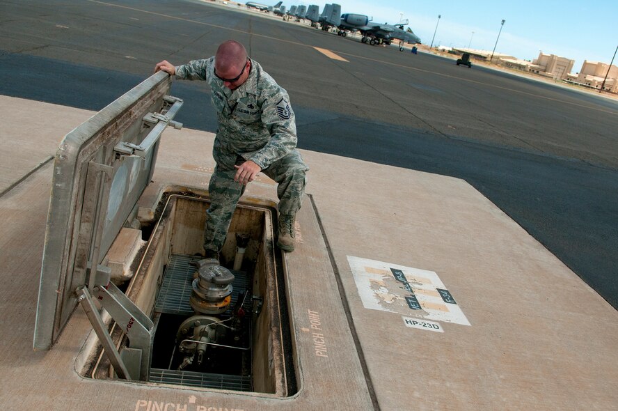 Master Sgt. Tony Karpenko, U.S. Naval Supply Fleet Logistic Center Pearl Harbor fuels department quality control inspector on Hickam Field, inspects a fuel hydrant outlet for cleanliness as part of an environmental spot operational check July 25. The Airmen operating the U.S. Naval Supply Fleet Logistic Center Pearl Harbor fuels department on Hickam Field pumped more than 10 million gallons of fuel to support air operations for RIMPAC. Twenty-two nations, more than 40 ships and submarines, more than 200 aircraft and 25,000 personnel are participating in RIMPAC exercise from Jun. 29 to Aug. 3, in and around the Hawaiian Islands. The world's largest international maritime exercise, RIMPAC provides a unique training opportunity that helps participants foster and sustain the cooperative relationships that are critical to ensuring the safety of sea lanes and security on the world's oceans. RIMPAC 2012 is the 23rd exercise in the series that began in 1971. (U.S. Air Force photo/Staff Sgt. Mike Meares)