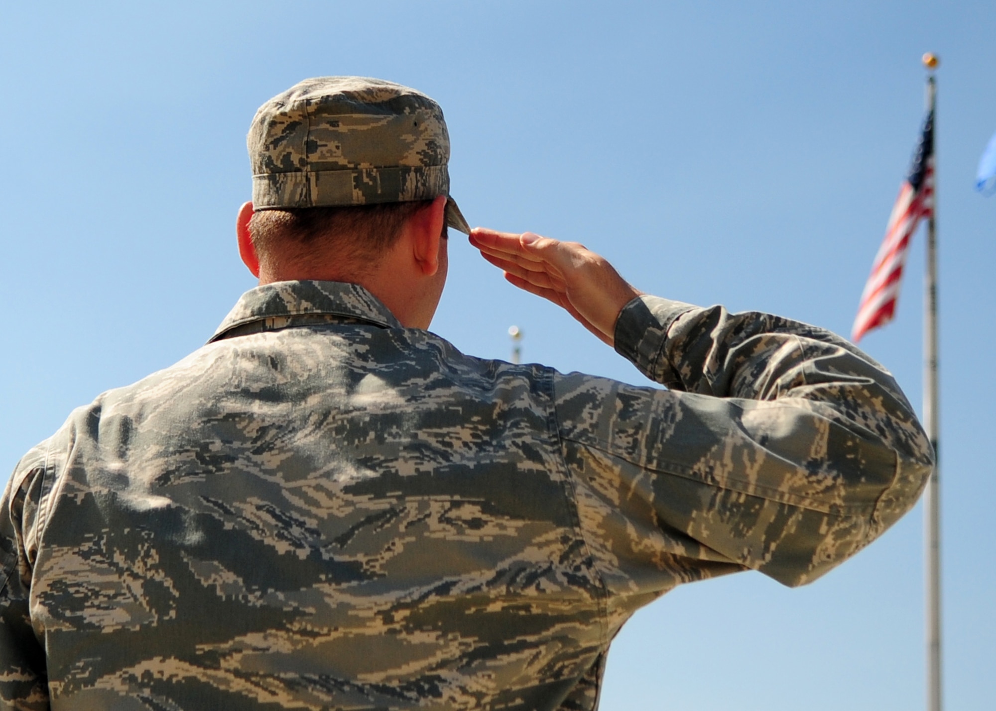 The giant voice system echoes music across the base four times throughout the day. Recently questions have arisen as how to properly show respect during these ceremonies. Col. Phil Stewart, 9th Reconnaissance Wing commander, and Chief Master Sgt. Robert White, 9th RW command chief, have strict expectations for these times of respect and remembrance. (U.S. Air Force photo by Senior Airman Shawn Nickel)