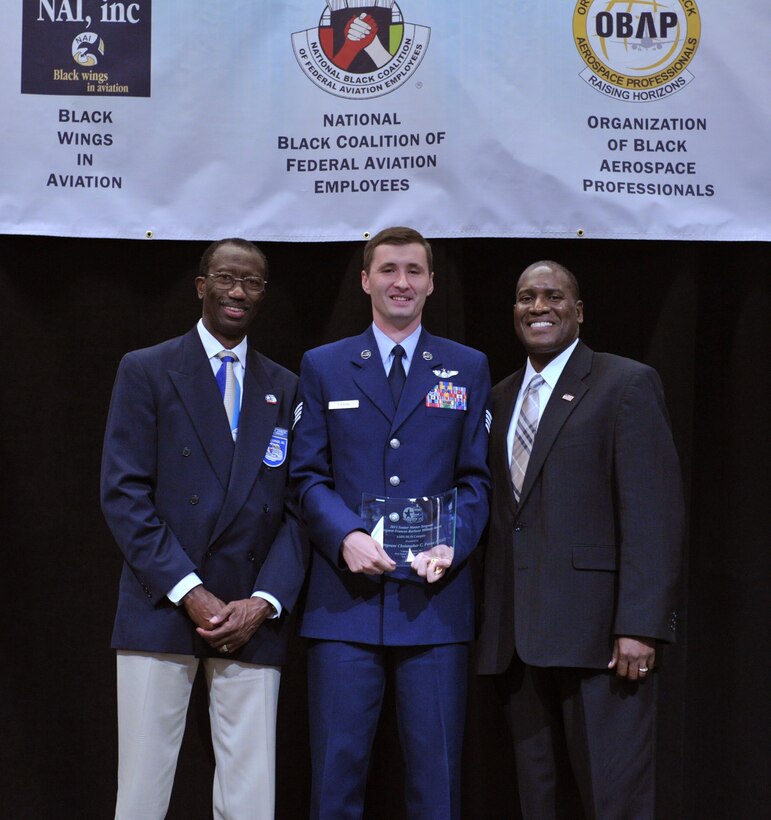 Staff Sgt. Christopher C. Faxon (center), Special Air Missions Communications Systems Operator at 99th Airlift Squadron, Joint Base Andrews, Md., is the winner of the Senior Master Sergeant Margaret Frances Barbour Military award. The winners of the Tuskegee Airmen, Inc. Military awards were announced during a luncheon at the Las Vegas Hotel, Aug. 1.

