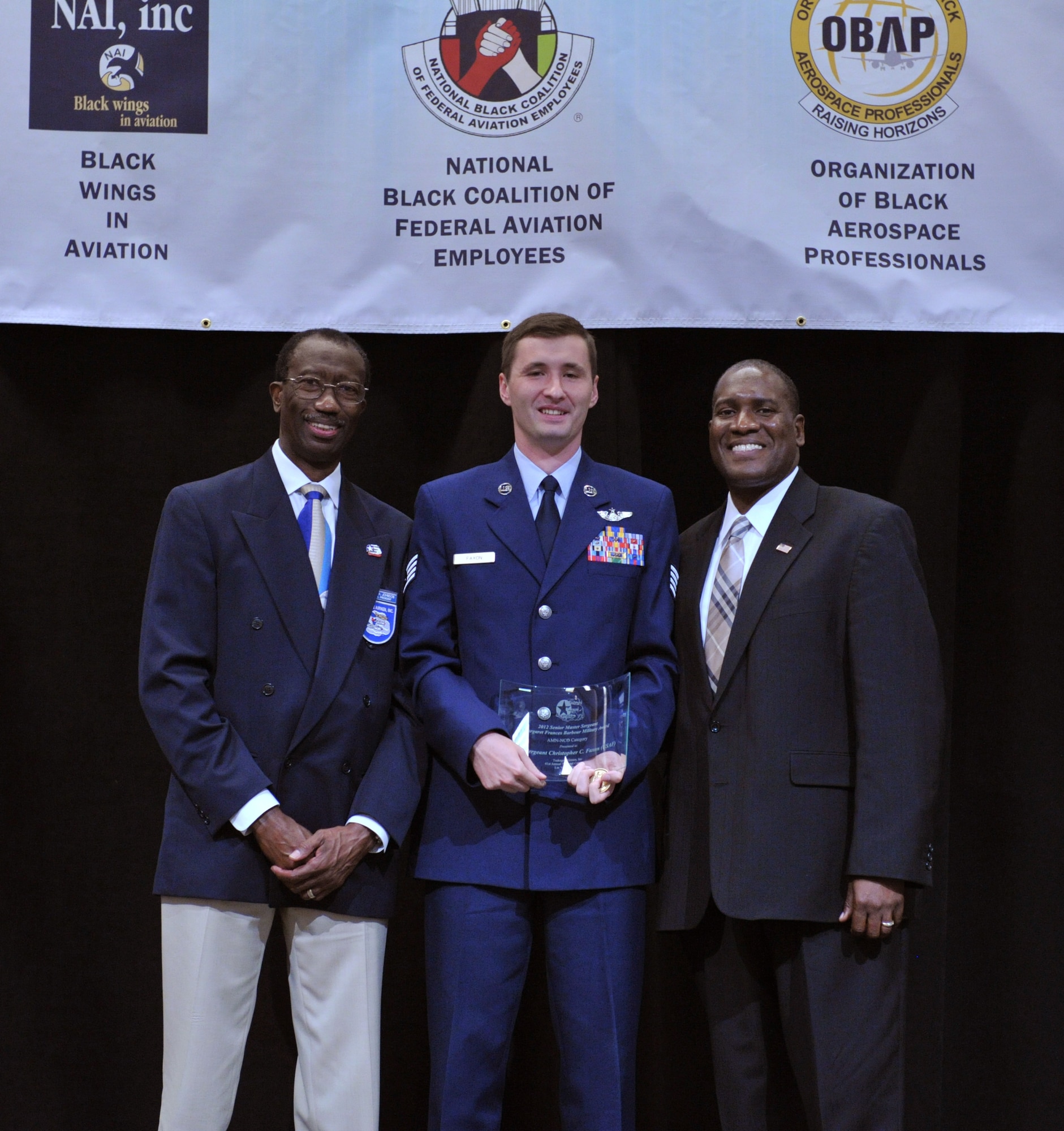 Staff Sgt. Christopher C. Faxon (center), Special Air Missions Communications Systems Operator at 99th Airlift Squadron, Joint Base Andrews, Md., is the winner of the Senior Master Sergeant Margaret Frances Barbour Military award. The winners of the Tuskegee Airmen, Inc. Military awards were announced during a luncheon at the Las Vegas Hotel, Aug. 1.


