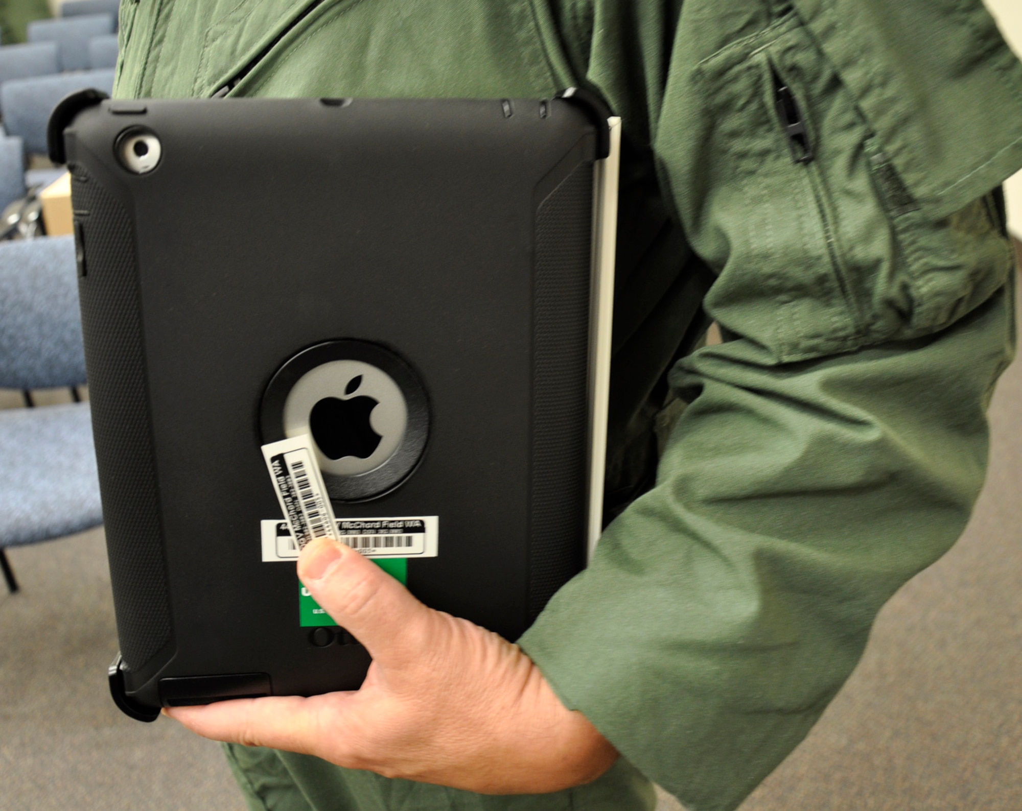 A McChord Reserve pilot from the 446th Airlift Wing, McChord Field, Wash., carries his newly issued Apple iPad 3 tablet in here, Aug 3, 2012. Air Mobility Command purchased almost 300 iPads for wing aircrews and they will eventually serve as their primary tool for information access during C-17 Globemaster III missions once the crews have been trained on them. (U.S. Air Force photo/Master Sgt. Jake Chappelle)

