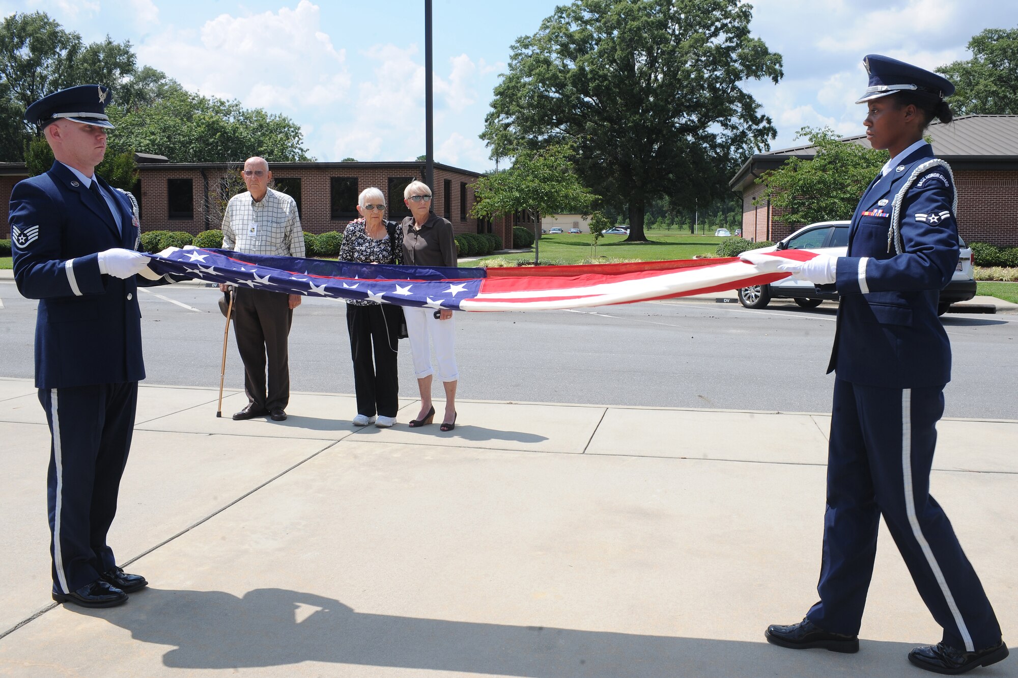 U.S. Air Force Staff Sgt. Frederick Burke and Airman 1st Class Stephanie Loftin, 4th Fighter Wing honor guardsmen, perform a flag-folding ceremony on Seymour Johnson Air Force Base, N.C., July 31, 2012. Special care is taken so that no part of the flag touches the ground as to not bring disrespect to the flag. (U.S. Air Force photo/Airman 1st Class John Nieves Camacho/Released)