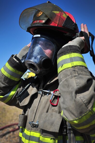 A firefighter with the Clovis, N.M. Fire Department secures his gear prior to training at Cannon Air Force Base, N.M., Aug. 2, 2012. Clovis firefighters were able to utilize base training facilities to conduct required annual training to stay current on tactics and strategy. (U.S. Air Force photo/Airman 1st Class Alexxis Pons Abascal) 