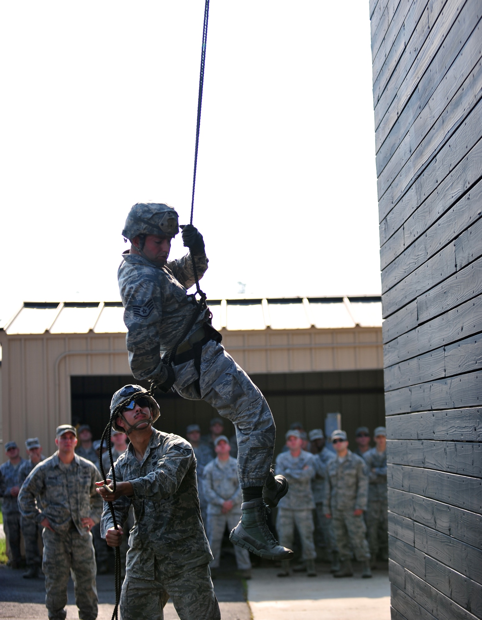 U.S. Air Force Staff Sgt. Moses Palermo and Senior Airman Dylan Vankerckhoven, 820th Base Defense Group, perform a rappel demonstration for Chief Master Sgt. Rick Parsons, command chief of Air Combat Command, during his visit to Moody Air Force Base, Ga., Aug. 2, 2012. Parsons started his career at Moody in 1985 and later held leadership positions with the 820th Security Forces Group (now the 820th Base Defense Group) in the late 90s and early 2000s. (U.S. Air Force photo by Staff Sgt. Stephanie Mancha/Released) 