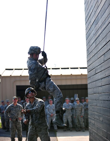 U.S. Air Force Staff Sgt. Moses Palermo and Senior Airman Dylan Vankerckhoven, 820th Base Defense Group, perform a rappel demonstration for Chief Master Sgt. Rick Parsons, command chief of Air Combat Command, during his visit to Moody Air Force Base, Ga., Aug. 2, 2012. Parsons started his career at Moody in 1985 and later held leadership positions with the 820th Security Forces Group (now the 820th Base Defense Group) in the late 90s and early 2000s. (U.S. Air Force photo by Staff Sgt. Stephanie Mancha/Released) 
