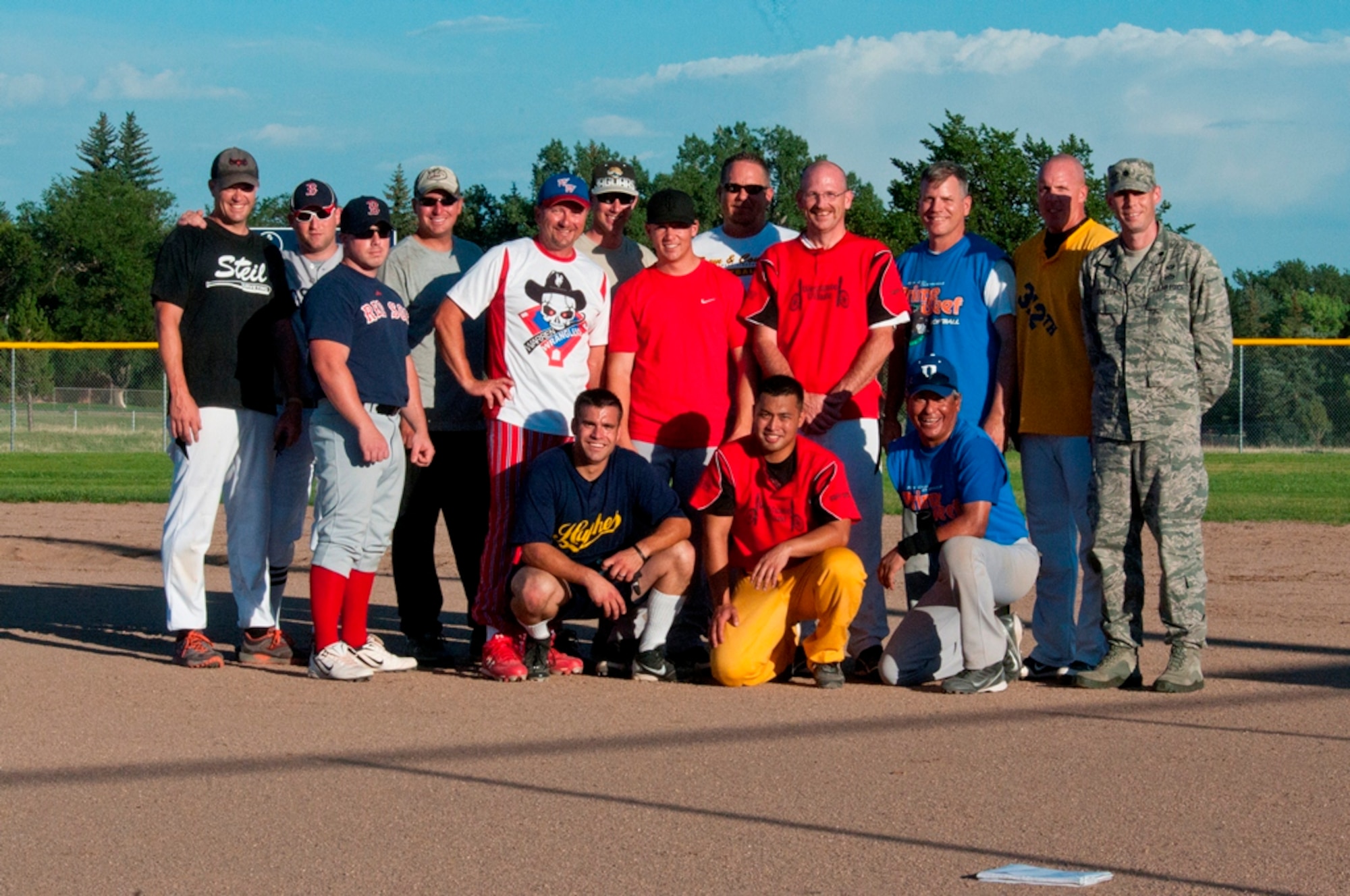 Lt. Col. Travis Leighton, 90th Civil Engineer Squadron commander, poses with members of the 90th CES softball team on one one of F. E. Warren’s ball fields July 19. The 90th CES won the tournament without a loss, and this victory marks their fifth consecutive softball tournament win. (U.S. Air Force photo by Airman 1st Class Jason Wiese)