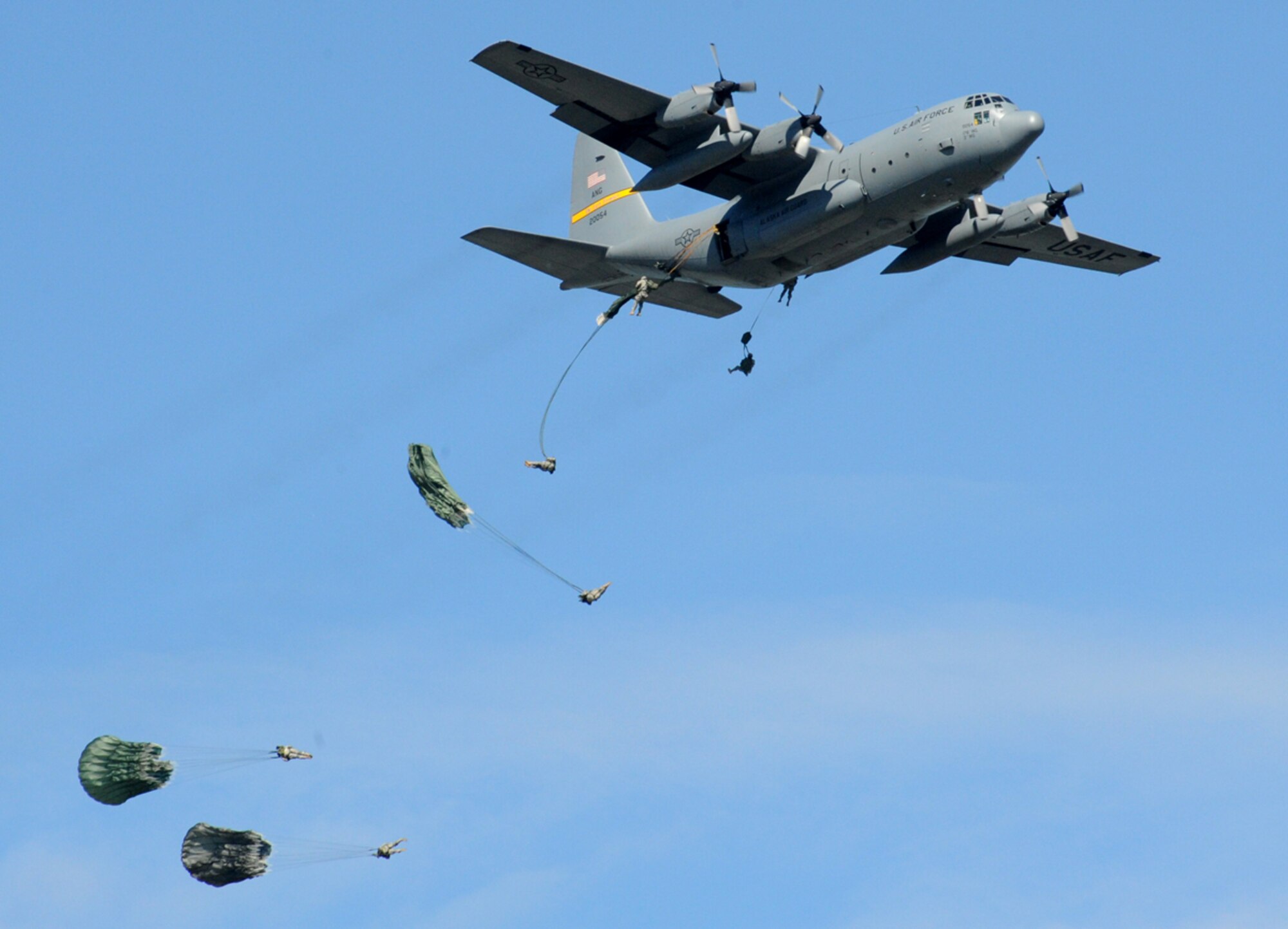 Forty paratroopers jump from two C-130 Hercules aircraft at Joint Base Elmendorf-Richardson's 2012 Arctic Thunder Open House July 28. The events of the open house included an all-star lineup, featuring the U.S. Air Force's Thunderbirds F-16 Flight Demonstration Team, the U.S. Army's Golden Knights Parachute Team and many other civilian and military performers. This award-winning show displayed Army and Air Force equipment our deployed warriors use to defend our nation. (U.S. Air Force photo/Senior Airman Blake Mize)