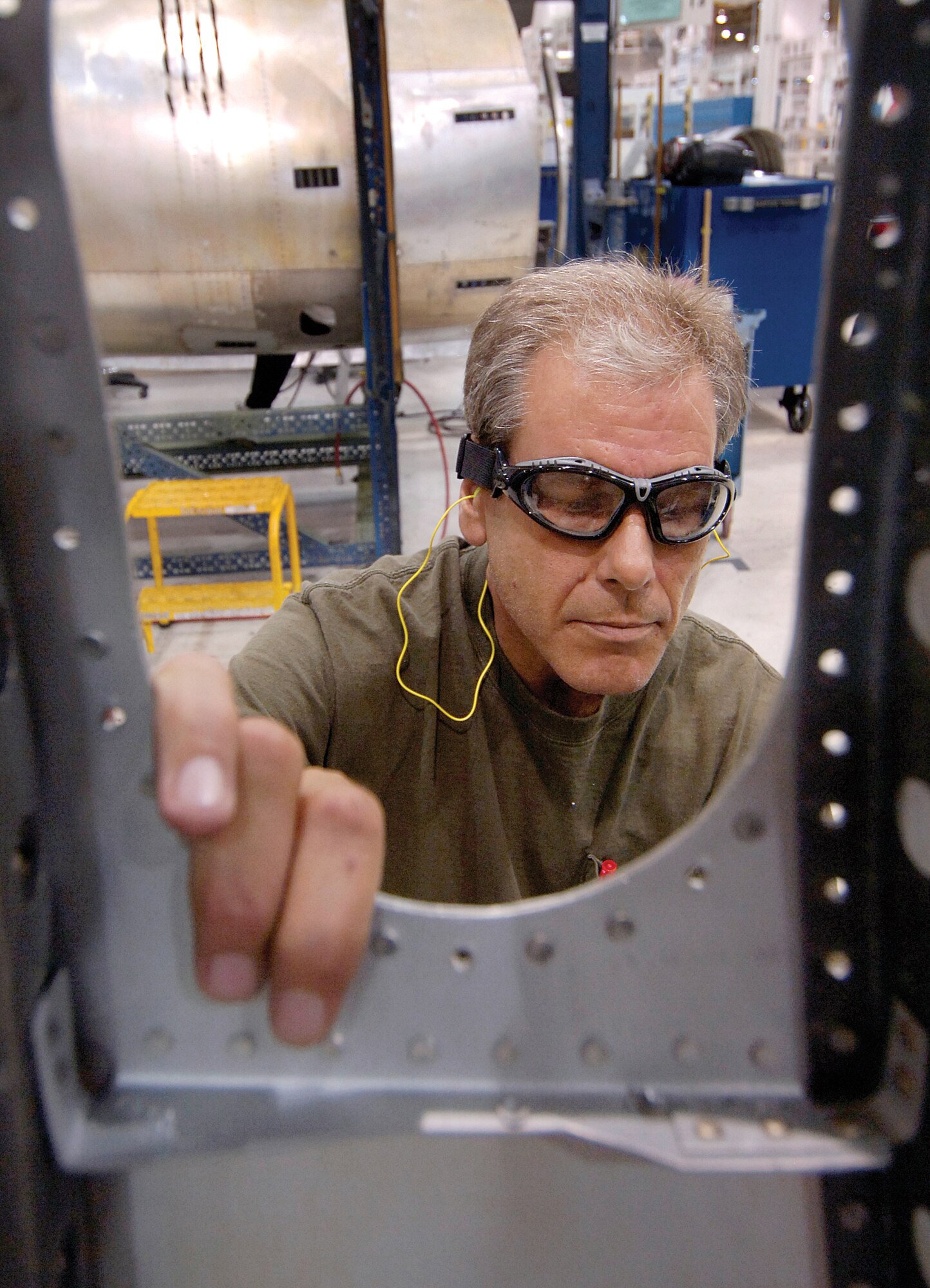 Derek Kirkland works on a B-52 side cowling in the shop of the 551st Commodities Maintenance Squadron, Bldg. 9001. (Air Force photo by Margo Wright)